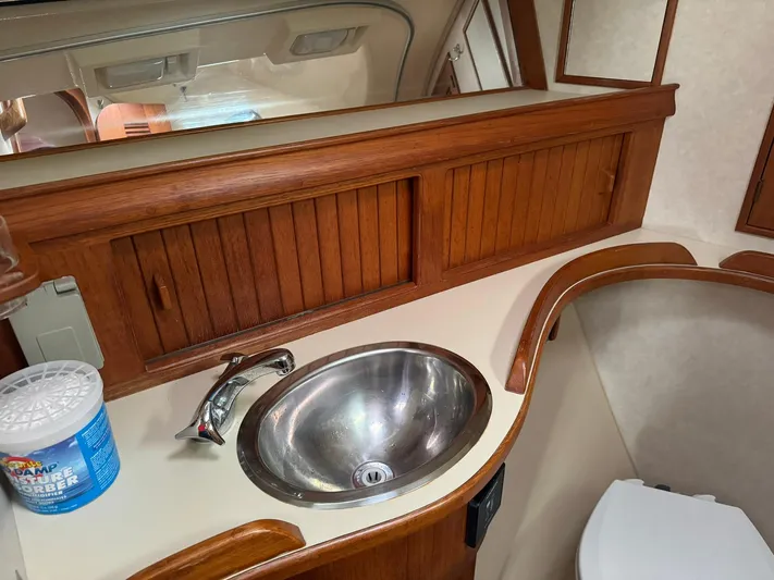 Essence Yacht Photos Pics Island Packet 40 yacht bathroom with wooden cabinets and stainless steel sink, 1998 model.