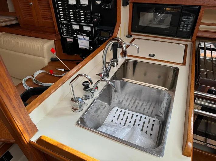Essence Yacht Photos Pics Island Packet 40 yacht kitchen sink area with dual faucets and microwave, 1998 model.