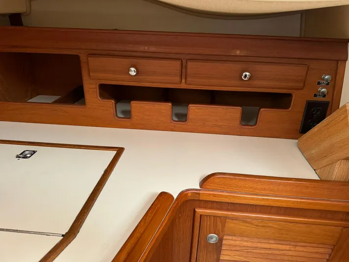 Essence Yacht Photos Pics Interior of 1998 Island Packet 40 sailboat with wooden cabinetry and storage compartments.