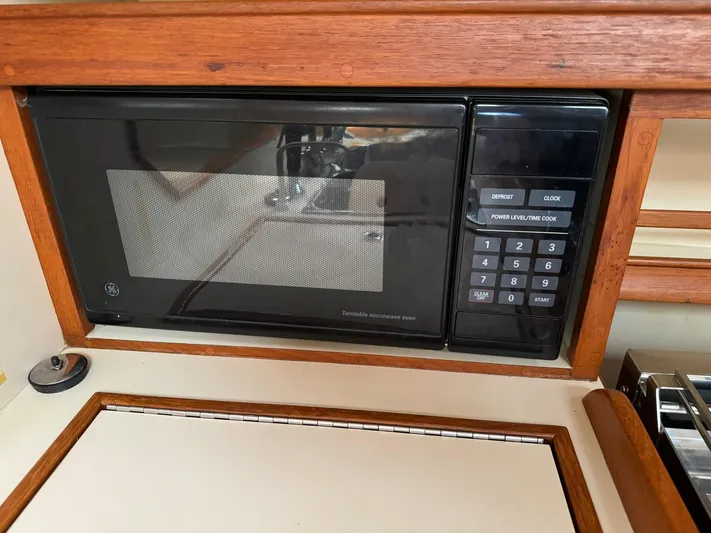 Essence Yacht Photos Pics Built-in microwave in 1998 Island Packet 40 yacht kitchen.