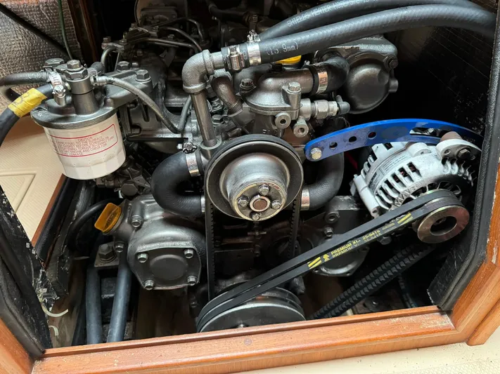 Essence Yacht Photos Pics Engine compartment of a 1998 Island Packet 40 sailboat, showing belts and components.