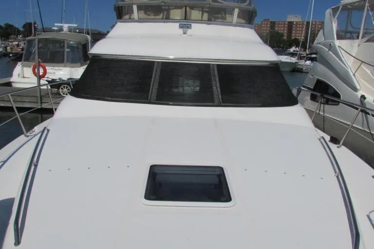  Yacht Photos Pics 2000 Sea Ray 400 Sedan Bridge yacht docked at marina, front view.