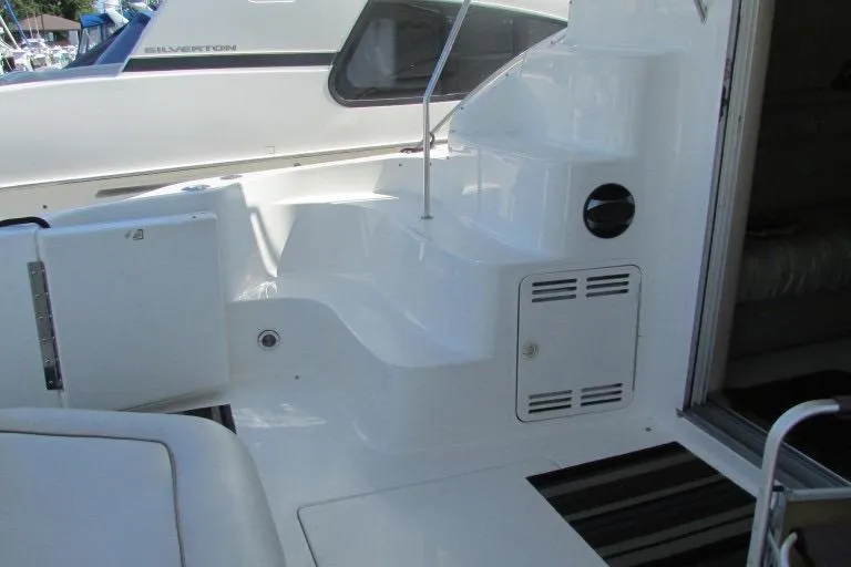  Yacht Photos Pics 2000 Sea Ray 400 Sedan Bridge yacht interior with white seating and steps.