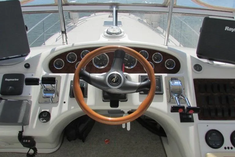  Yacht Photos Pics Cockpit of 2000 Sea Ray 400 Sedan Bridge with wooden steering wheel and control panel.