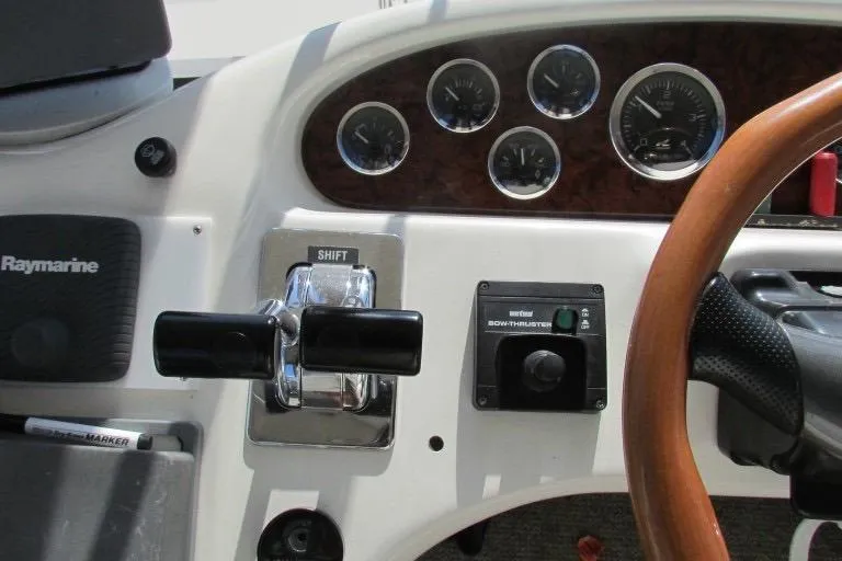  Yacht Photos Pics Control panel of a 2000 Sea Ray 400 Sedan Bridge boat with gauges and steering wheel.