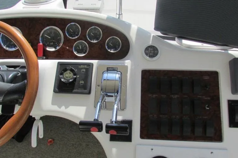  Yacht Photos Pics Control panel of a 2000 Sea Ray 400 Sedan Bridge yacht with gauges and throttle levers.