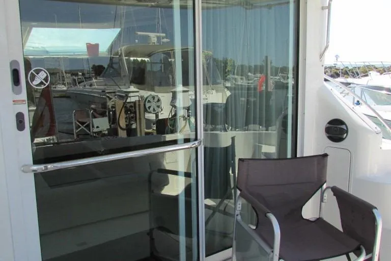  Yacht Photos Pics 2000 Sea Ray 400 Sedan Bridge yacht with glass doors and outdoor seating.