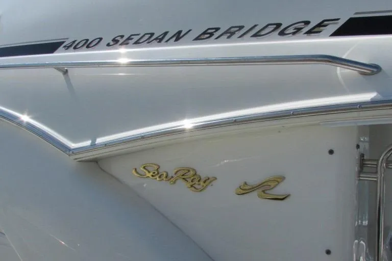  Yacht Photos Pics 2000 Sea Ray 400 Sedan Bridge boat with sleek white exterior and elegant branding.