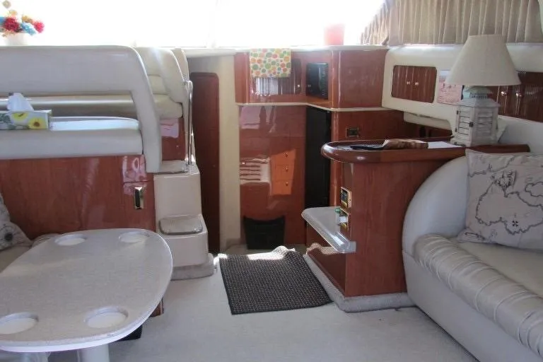  Yacht Photos Pics Interior of a 2000 Sea Ray 400 Sedan Bridge yacht, featuring elegant seating and wood finishes.