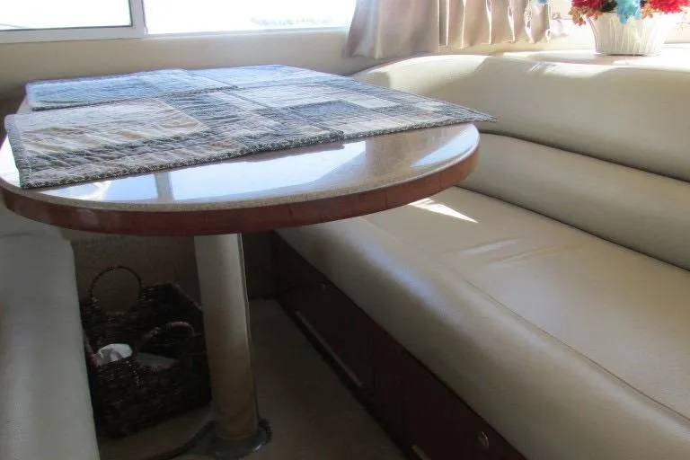  Yacht Photos Pics Interior of 2000 Sea Ray 400 Sedan Bridge with dining table and leather seating.