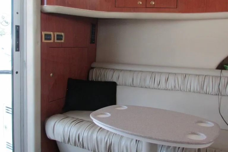  Yacht Photos Pics Interior of 2000 Sea Ray 400 Sedan Bridge with seating and table.