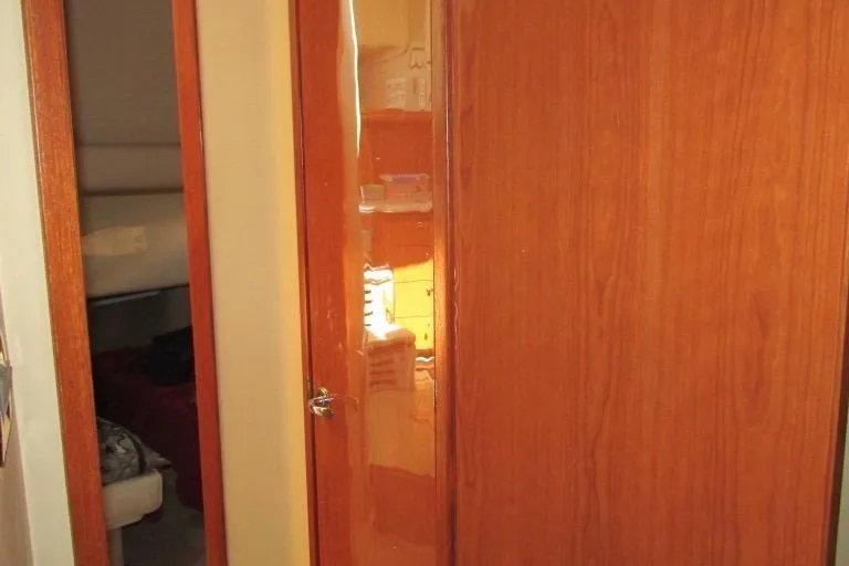  Yacht Photos Pics Interior view of 2000 Sea Ray 400 Sedan Bridge with wooden doors and cozy cabin.