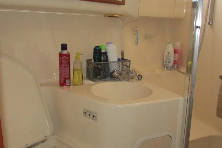  Yacht Photos Pics Bathroom interior of 2000 Sea Ray 400 Sedan Bridge yacht with toiletries and sink.