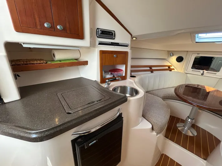 She Bot It II Yacht Photos Pics 2007 Grady-White Express 305 cabin interior with kitchenette and seating area.