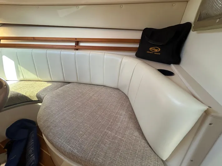She Bot It II Yacht Photos Pics 2007 Grady-White Express 305 interior with cushioned seating and branded bag.