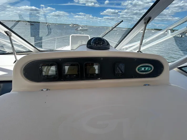 She Bot It II Yacht Photos Pics 2007 Grady-White Express 305 boat dashboard with ocean view and clear sky.