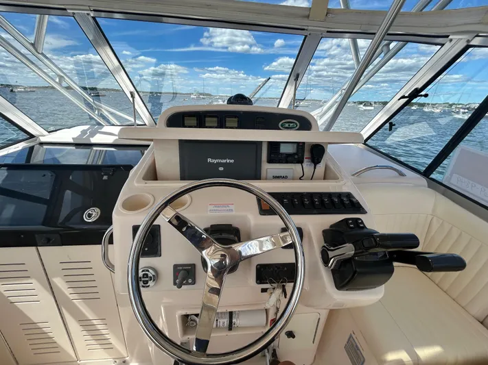 She Bot It II Yacht Photos Pics 2007 Grady-White Express 305 helm with steering wheel and navigation equipment.