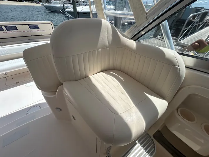 She Bot It II Yacht Photos Pics 2007 Grady-White Express 305 boat interior with cream leather seating, docked at marina.