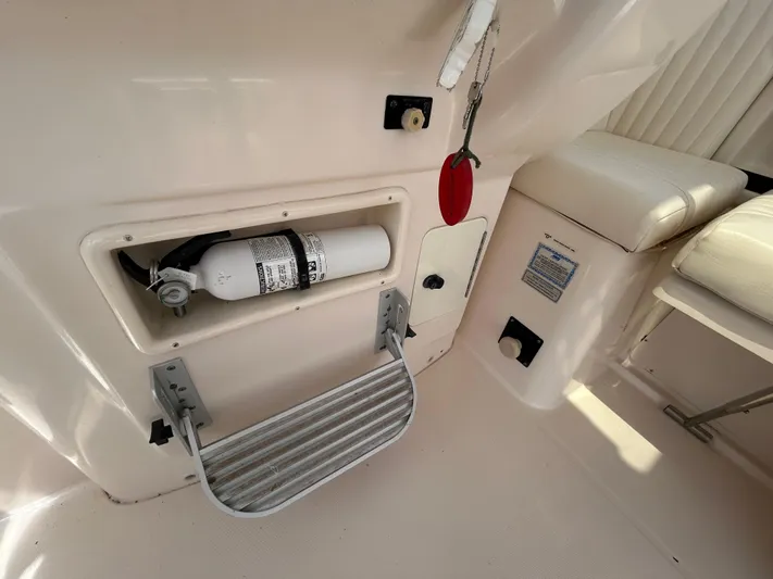 She Bot It II Yacht Photos Pics 2007 Grady-White Express 305 interior with fire extinguisher and seating area.