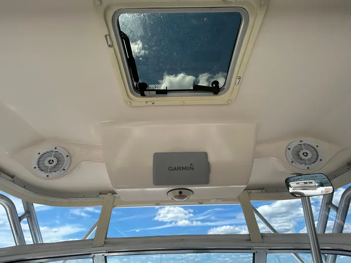 She Bot It II Yacht Photos Pics 2007 Grady-White Express 305 boat interior with Garmin system and speakers, under a blue sky.