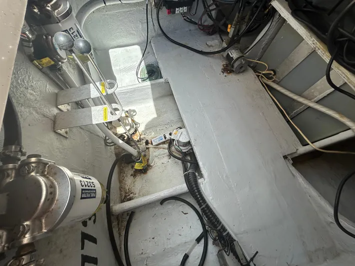 She Bot It II Yacht Photos Pics Engine compartment of a 2007 Grady-White Express 305 boat, showing mechanical components and wiring.