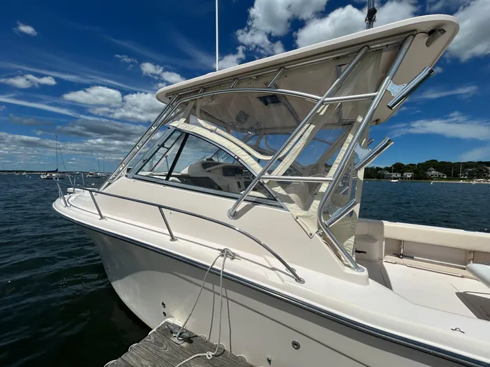 She Bot It II Yacht Photos Pics 2007 Grady-White Express 305 boat docked under a clear blue sky.