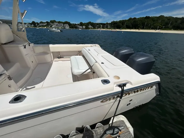 She Bot It II Yacht Photos Pics 2007 Grady-White Express 305 boat docked on calm water, scenic shoreline in background.