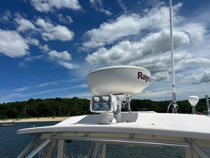 She Bot It II Yacht Photos Pics 2007 Grady-White Express 305 boat with radar, under a partly cloudy sky.