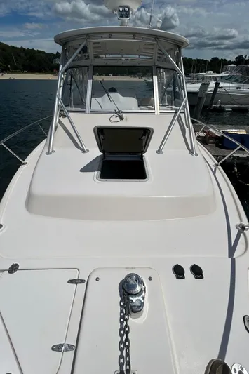 She Bot It II Yacht Photos Pics 2007 Grady-White Express 305 boat docked, open hatch, clear sky, calm water.