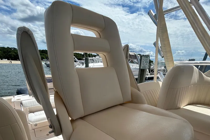 She Bot It II Yacht Photos Pics 2007 Grady-White Express 305 boat seat with marina background.