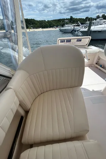 She Bot It II Yacht Photos Pics 2007 Grady-White Express 305 boat interior with beige seating, docked near other boats.