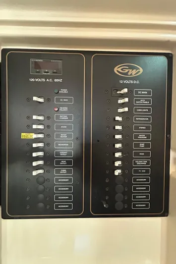 She Bot It II Yacht Photos Pics Electrical panel of a 2007 Grady-White Express 305 boat, showing 120V AC and 12V DC switches.