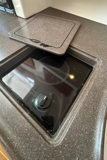 She Bot It II Yacht Photos Pics 2007 Grady-White Express 305 boat stove with cover, sleek countertop design.