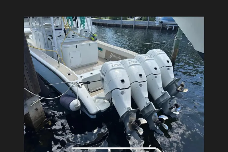  Yacht Photos Pics 2011 Yellowfin 42 Offshore boat with four powerful outboard engines docked at marina.