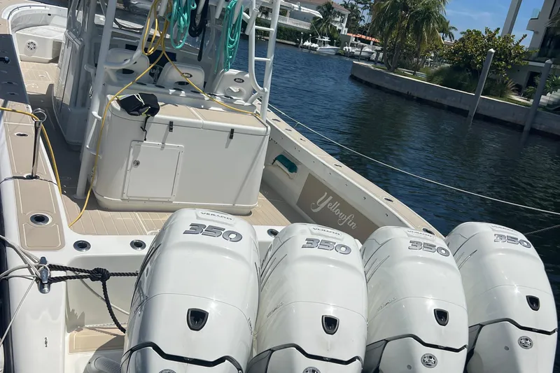  Yacht Photos Pics 2011 Yellowfin 42 Offshore boat with four powerful outboard engines docked by the water.