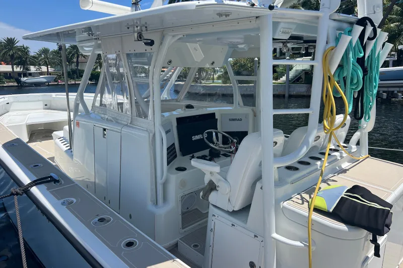  Yacht Photos Pics 2011 Yellowfin 42 Offshore boat with helm, ropes, and seating in a marina setting.