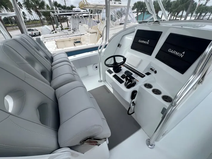 No Name Yacht Photos Pics 2022 Contender 39 Fisharound boat cockpit with dual Garmin displays and plush seating.