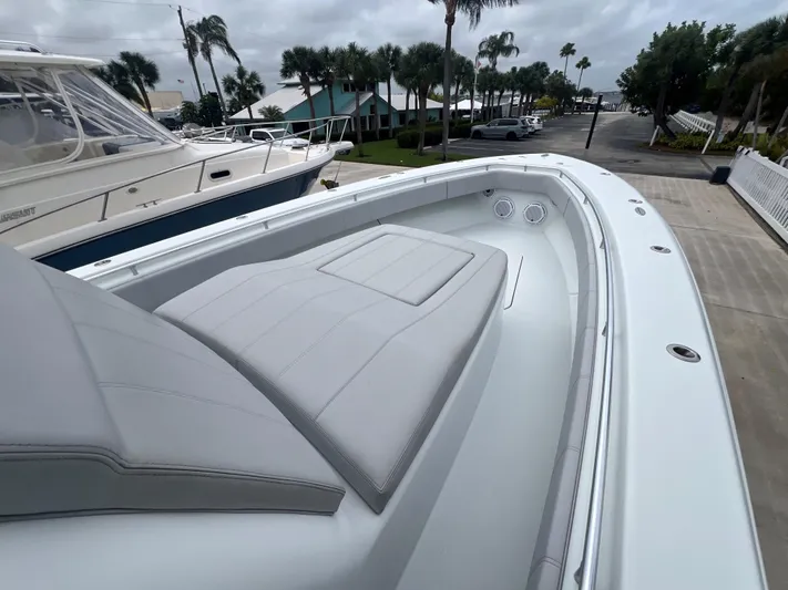 No Name Yacht Photos Pics 2022 Contender 39 Fisharound boat with sleek deck design, docked near palm trees.
