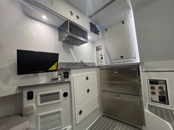 No Name Yacht Photos Pics 2022 Contender 39 Fisharound interior with modern kitchen and sleek cabinetry.