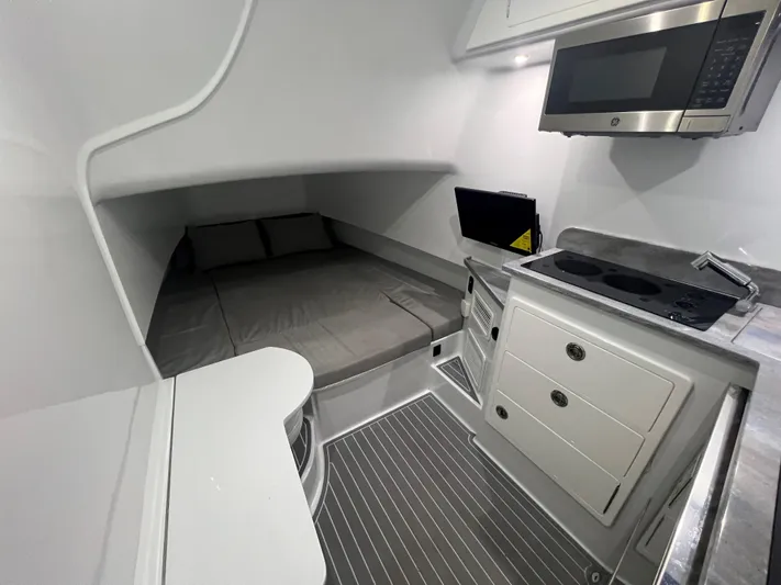 No Name Yacht Photos Pics 2022 Contender 39 Fisharound cabin with bed, kitchenette, and modern appliances.