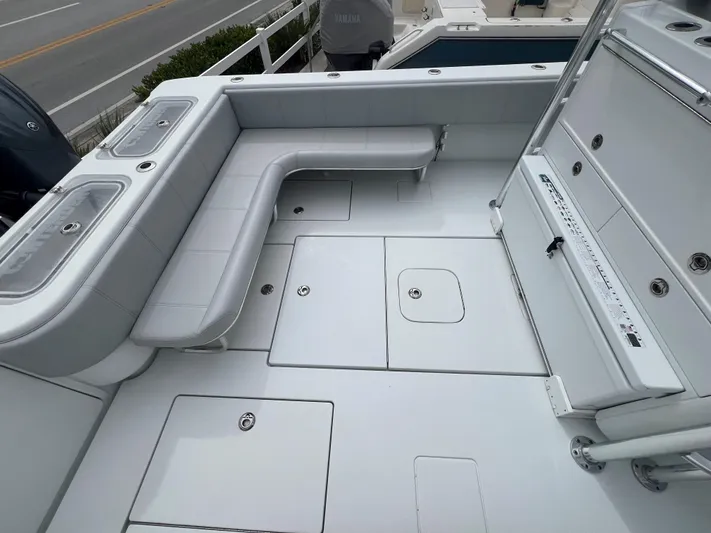 No Name Yacht Photos Pics 2022 Contender 39 Fisharound boat deck with seating and storage compartments.