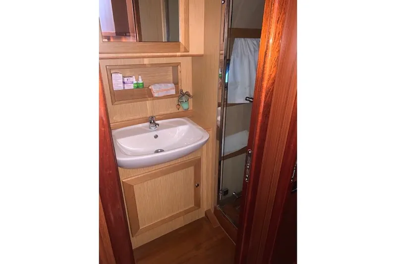  Yacht Photos Pics Bathroom interior of 2007 Apreamare 48 yacht with sink and wooden cabinetry.