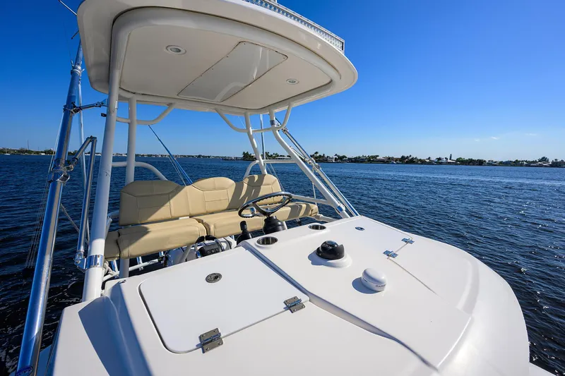 40 Pursuit 2017 Yacht Photos Pics 2017 Pursuit S408 boat helm with seating, cruising on open water under clear blue sky.