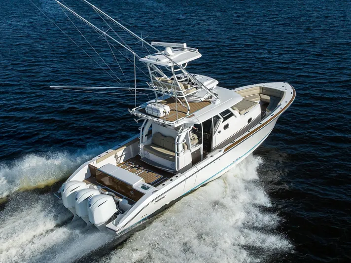 40 Pursuit 2017 Yacht Photos Pics 2017 Pursuit S408 boat cruising on open water, showcasing sleek design and powerful engines.