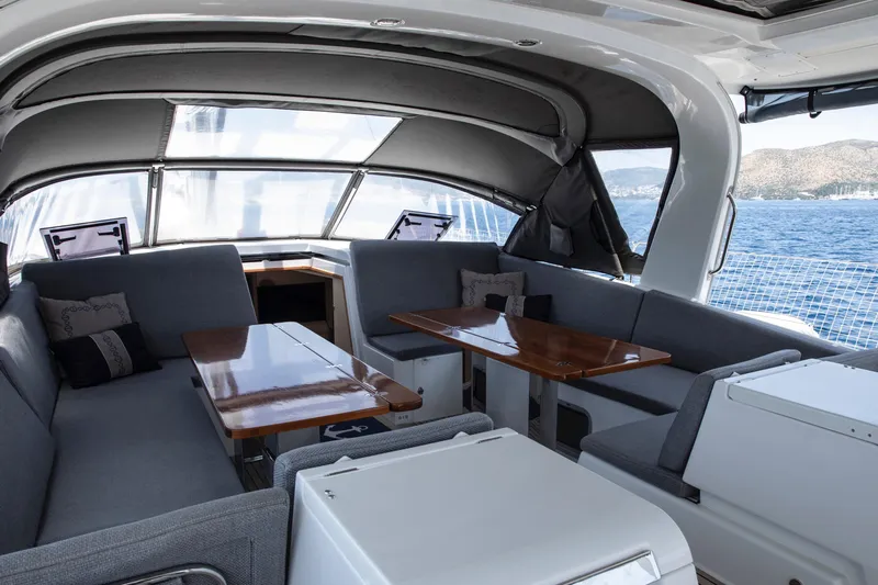  Yacht Photos Pics Luxurious interior of 2020 Jeanneau 64 yacht with elegant seating and ocean view.