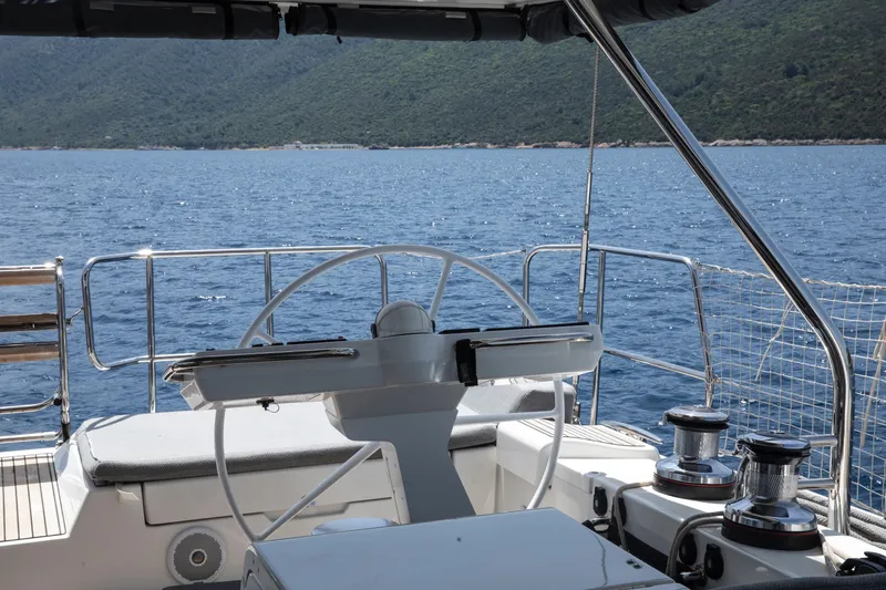  Yacht Photos Pics Cockpit view of 2020 Jeanneau 64 yacht sailing on a serene blue sea.