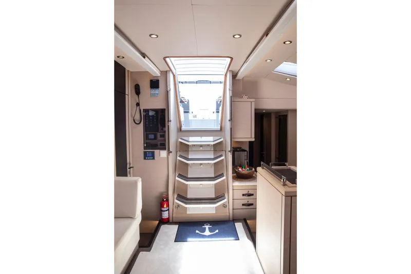  Yacht Photos Pics Interior of 2020 Jeanneau 64 yacht, featuring stairs, control panel, and modern design.