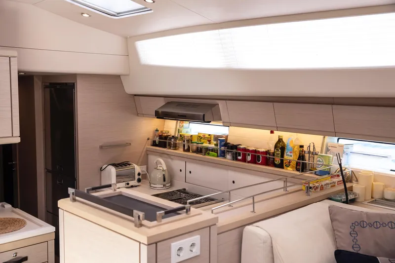  Yacht Photos Pics Luxurious Jeanneau 64 yacht kitchen interior, featuring modern appliances and sleek design, 2020 model.