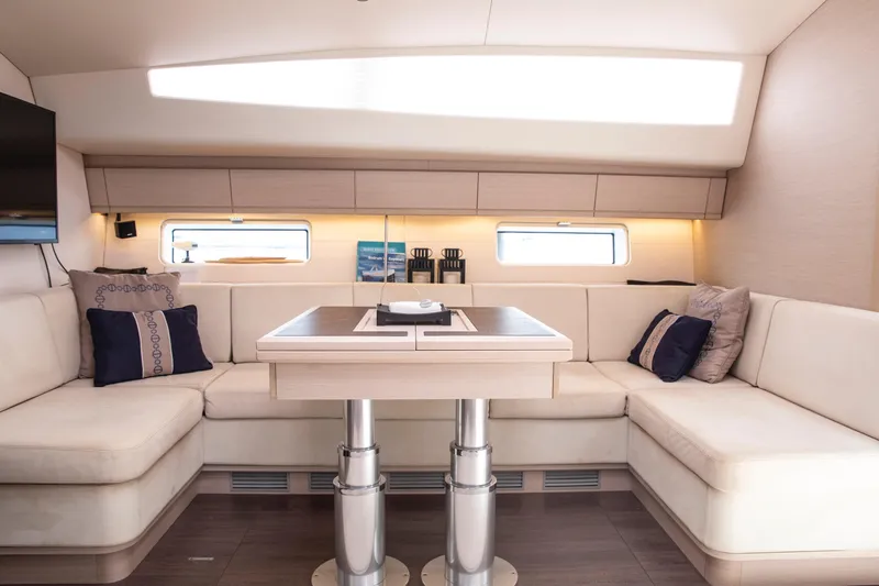  Yacht Photos Pics Luxurious interior of 2020 Jeanneau 64 yacht with elegant seating and modern decor.