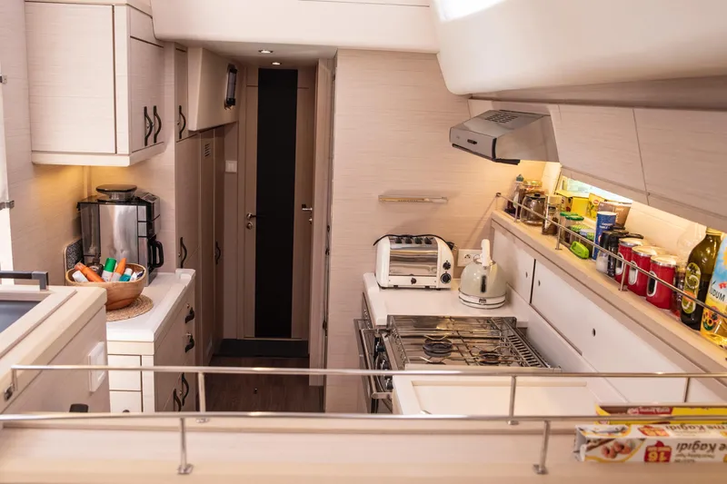  Yacht Photos Pics Modern kitchen interior of 2020 Jeanneau 64 yacht with appliances and storage.